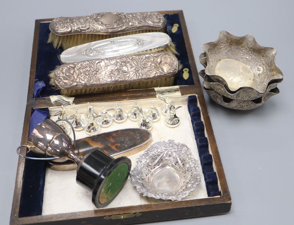 A set of four Indian white metal bon-bon dishes, 11cm, a silver nut dish, a small trophy cup and sundries